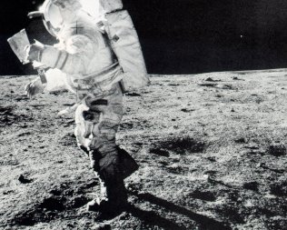 A photo of astronaut Mitchell looking at a map on his way to Cone crater