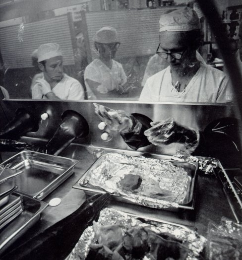 A photo of scientists examining samples brought from the Apollo 14 mission