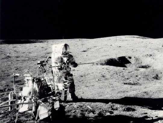 A photo of astronaut Shepard holding a core tube section