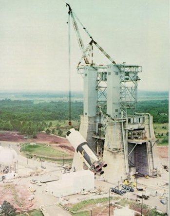 A photo of the S-IC stage being hoisted into the static test stand