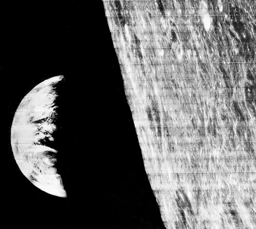 A photo of the Earth rise over the eastern rim of the Moon