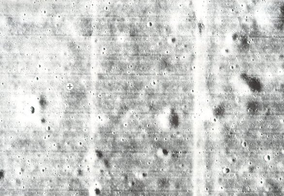 A photo of where Apollo 11 landing module descended indicated by the black cross