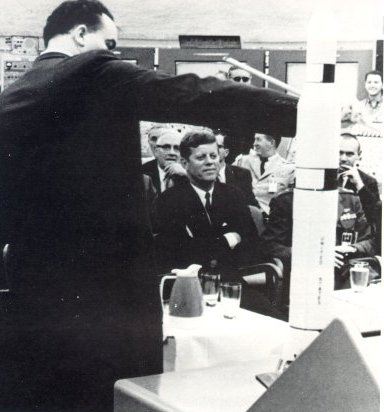 A photo of President John F. Kennedy being briefed on Launch Complex 39