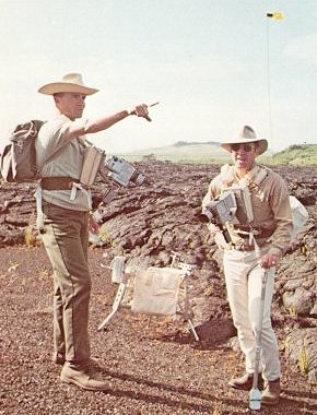 A photo of Apollo 13 astronauts,Haise and Lovell observing lava flow