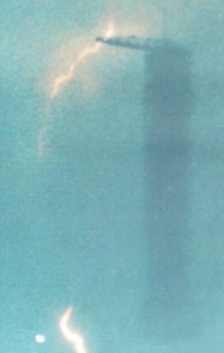 A photo of a lightning bolt striking Apollo 12 and crane