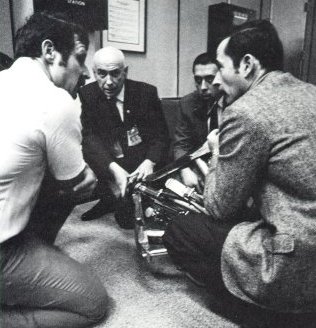 A photo of Llewellyn with Gilruth,Abbey,and Young discussing docking procedure