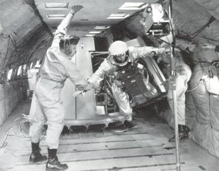 A photo of astronaut exiting through a spacecraft hatch