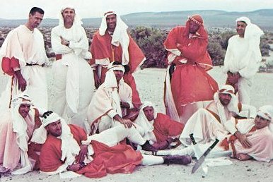 A photo of astronauts and training officiers dressed in Arab clothes fashion using spacecraft parachutes