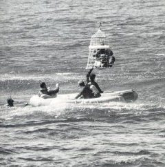 A photo of Apollo 7 astronaut being hoisted up to helicopter