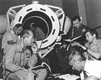 Crewmen practice in the docking module mockup